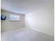 Spacious bedroom offers a window for natural light and neutral carpeting at 7307 Summerbridge Dr, Tampa, FL 33634