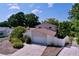 Two-story home with an attached garage, nicely landscaped yard, and paved driveway on a sunny day at 7307 Summerbridge Dr, Tampa, FL 33634