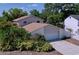 Two-story home shows an attached garage and nicely landscaped yard on a sunny day at 7307 Summerbridge Dr, Tampa, FL 33634