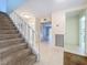 Well-lit foyer boasts tile floors and staircase to upper level at 7307 Summerbridge Dr, Tampa, FL 33634