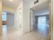 Hallway with tile flooring leads to the bathroom and living room area at 7307 Summerbridge Dr, Tampa, FL 33634