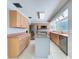 Open kitchen with island offers stainless appliances, a large window, and ample storage at 7307 Summerbridge Dr, Tampa, FL 33634