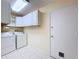 Clean laundry room features tiled floors, modern appliances, and ample cabinet space at 7307 Summerbridge Dr, Tampa, FL 33634