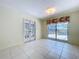 Sunny room with tile flooring, doors to the outside, and a large window overlooking the pool area at 7307 Summerbridge Dr, Tampa, FL 33634