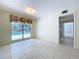 Bright room with tile flooring and a large window offering a view of the pool area at 7307 Summerbridge Dr, Tampa, FL 33634