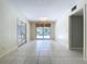 Bright room with tile flooring, doors to the outside, and a window overlooking the pool area at 7307 Summerbridge Dr, Tampa, FL 33634