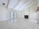 Large living room featuring tile flooring, a fireplace, and double doors to the outside at 7307 Summerbridge Dr, Tampa, FL 33634