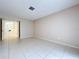 Spacious living room with tile floors, neutral walls, and an open doorway at 7307 Summerbridge Dr, Tampa, FL 33634