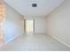Open living room featuring tile floors, neutral walls, and a view of the staircase at 7307 Summerbridge Dr, Tampa, FL 33634