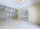 Large room with tile flooring and glass doors providing views of the outdoors and ample natural light at 7307 Summerbridge Dr, Tampa, FL 33634