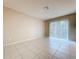 Bright living room with tile floors and a sliding glass door to the outdoors at 7307 Summerbridge Dr, Tampa, FL 33634