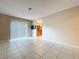 Open living room with tile floors offers a sliding glass door and entryway to the kitchen at 7307 Summerbridge Dr, Tampa, FL 33634