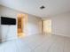 Inviting living room with tile floors leading to a tiled bathroom and staircase at 7307 Summerbridge Dr, Tampa, FL 33634