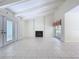 Spacious living room with vaulted ceilings, fireplace, tile floors, and natural light at 7307 Summerbridge Dr, Tampa, FL 33634