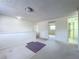 Spacious loft area with neutral carpeting, white walls, and natural light at 7307 Summerbridge Dr, Tampa, FL 33634