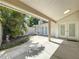 Covered patio features lush tropical landscaping and double glass doors at 7307 Summerbridge Dr, Tampa, FL 33634