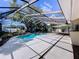 Backyard pool surrounded by a screened enclosure at 7307 Summerbridge Dr, Tampa, FL 33634