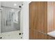 Contemporary shower with sleek gray tiling and a glass door, adjacent to modern wooden cabinets at 777 3Rd N Ave # 1408, St Petersburg, FL 33701