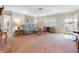 Inviting living room with plush carpet, plantation shutters, and neutral decor at 9110 34 N Way, Pinellas Park, FL 33782