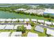 Gorgeous aerial view of a waterfront property with lush landscaping and nearby commercial area at 9110 34 N Way, Pinellas Park, FL 33782