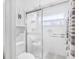 Clean, organized bathroom with glass enclosed shower and built in storage at 9110 34 N Way, Pinellas Park, FL 33782