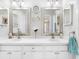 Bathroom with dual sinks, vanity mirrors, and white countertops at 9110 34 N Way, Pinellas Park, FL 33782