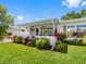 Charming single-story home with a well-manicured lawn and colorful, tropical landscaping in the front yard at 9110 34 N Way, Pinellas Park, FL 33782