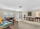 Inviting living room features new flooring, plantation shutters, and a glass front door at 9110 34 N Way, Pinellas Park, FL 33782