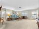 Cozy living room with hardwood flooring, decor lighting, and a glass sliding door for natural lighting at 9110 34 N Way, Pinellas Park, FL 33782