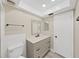 Bathroom featuring a single sink vanity with storage and updated fixtures and hardware at 100 Glennes Ln # 108, Dunedin, FL 34698