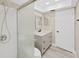 Bathroom featuring a single sink vanity with storage and updated fixtures and a walk-in shower at 100 Glennes Ln # 108, Dunedin, FL 34698