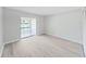 This bedroom features modern vinyl floors, neutral paint and sliding glass doors to the outside at 100 Glennes Ln # 108, Dunedin, FL 34698