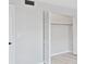 Bedroom closet with bi-fold doors and rod for hanging clothes at 100 Glennes Ln # 108, Dunedin, FL 34698