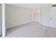 This bedroom offers a neutral color palette, vinyl plank flooring and a closet with folding doors at 100 Glennes Ln # 108, Dunedin, FL 34698