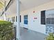 Welcoming condo entrance featuring classic architectural details and a secure entrance, unit #109 at 100 Glennes Ln # 108, Dunedin, FL 34698
