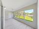 The screened-in lanai has vinyl plank flooring, a ceiling fan, and a view of the outdoors at 100 Glennes Ln # 108, Dunedin, FL 34698