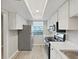 Modern kitchen featuring stainless steel appliances, countertops, and a bright, airy atmosphere at 100 Glennes Ln # 108, Dunedin, FL 34698