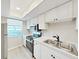 Bright kitchen featuring stainless steel appliances, modern countertops, and ample storage at 100 Glennes Ln # 108, Dunedin, FL 34698
