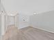 Bright living room featuring light gray walls, light wood floors, and an opening into the kitchen at 100 Glennes Ln # 108, Dunedin, FL 34698