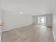 Bright living room featuring light gray walls, light wood floors, and sliding glass doors at 100 Glennes Ln # 108, Dunedin, FL 34698