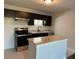 Well-appointed kitchen with granite countertops, stainless steel appliances, and black cabinetry at 10200 Gandy N Blvd # 1133, St Petersburg, FL 33702