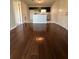 Open-concept living room with stylish wood floors and a view into the modern kitchen at 10200 Gandy N Blvd # 1133, St Petersburg, FL 33702