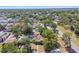 An aerial view shows a charming residential neighborhood with lush trees and well-maintained homes at 1046 Yale N St, St Petersburg, FL 33713