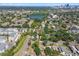 This aerial view captures a serene neighborhood with a mix of housing and a tranquil lake at 1046 Yale N St, St Petersburg, FL 33713