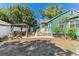 The backyard offers a patio, gazebo, green home exterior, and a secure white fence for added privacy at 1046 Yale N St, St Petersburg, FL 33713