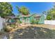 Expansive backyard view showcases green home exterior, gazebo, deck, and white fencing, perfect for outdoor enjoyment at 1046 Yale N St, St Petersburg, FL 33713