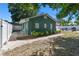 A beautifully landscaped backyard featuring mature trees and a newly installed white fence at 1046 Yale N St, St Petersburg, FL 33713