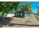 Exterior view of a house with mature trees and a classic wooden fence at 1046 Yale N St, St Petersburg, FL 33713