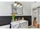 Bathroom featuring a vanity with decorative flowers, black and white wainscotting, and decorative tile floor at 1046 Yale N St, St Petersburg, FL 33713