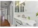Bright bathroom featuring a modern vanity, brushed gold faucet, decorative mirror, and views to the hallway at 1046 Yale N St, St Petersburg, FL 33713